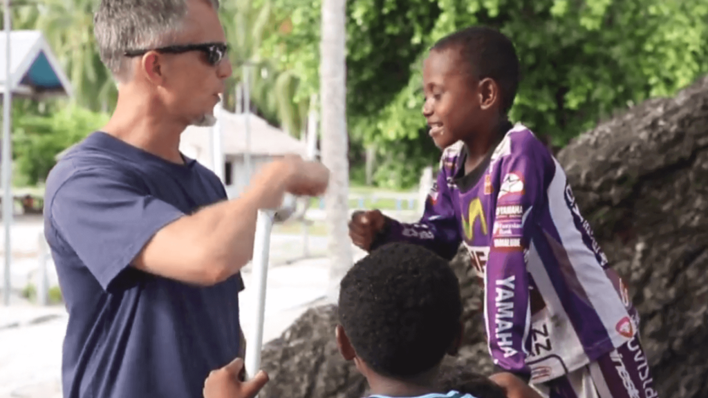 Raw Travel TV Host, Rob Rose with two Indonesian children