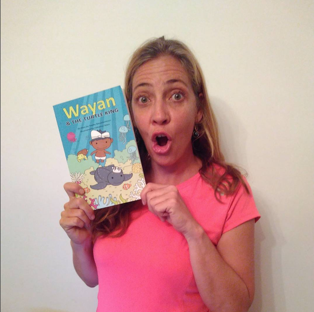 Yvette and her "Wayan and the Turtle King" book